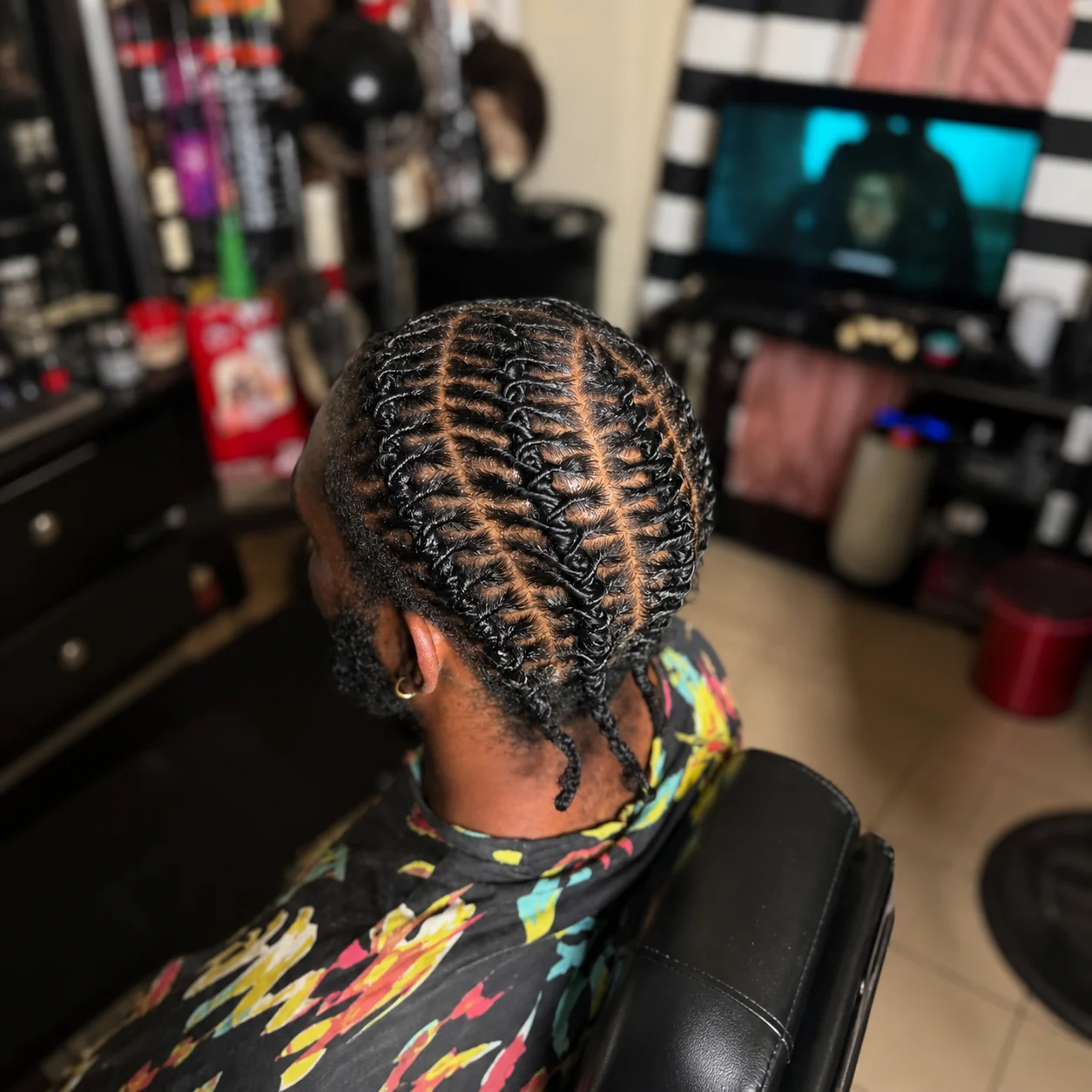 Braided protective style representing men’s services
